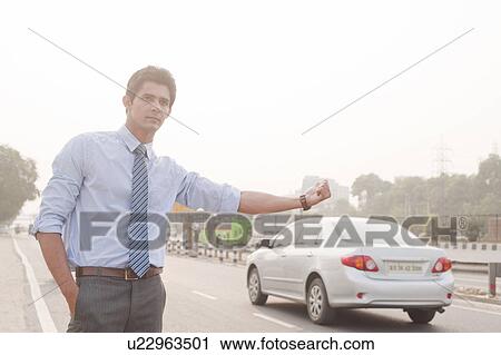 Businessman hitchhiking, Gurgaon, Haryana, India View Large Photo Image Stock Image - Businessman hitchhiking, Gurgaon, Haryana, India. Fotosearch