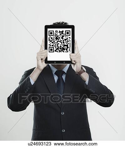 Businessman holding a digital tablet in front of his face with 2D barcode on it View Large Photo Image Stock Image - Businessman holding a digital tablet in front of his face with 2D barcode on it. Fotosearch