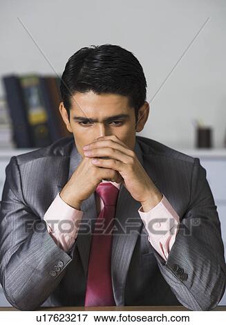Stock Photo - Businessman looking disappointed in an office. Fotosearch