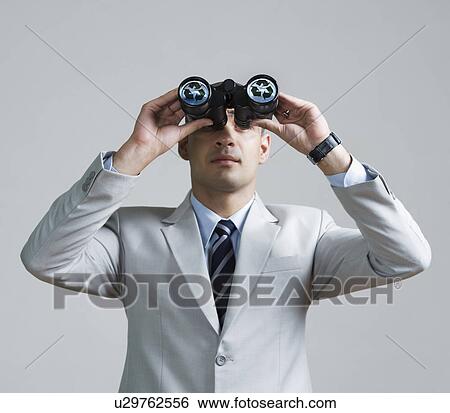 Businessman looking through binoculars View Large Photo Image Stock Photograph - Businessman looking through binoculars. Fotosearch