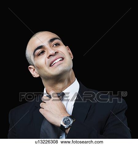 Stock Photo - Businessman loosening his tie. Fotosearch
