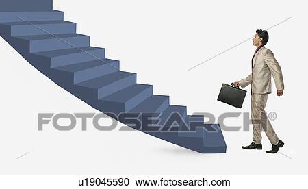 Stock Image - Businessman moving up staircase. Fotosearch
