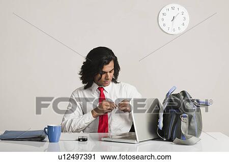 Businessman preparing to leave the office View Large Photo Image Stock Image - Businessman preparing to leave the office. Fotosearch