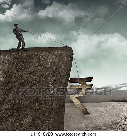 Businessman pulling a rupee symbol from a cliff View Large Photo Image Stock Image - Businessman pulling a rupee symbol from a cliff. Fotosearch
