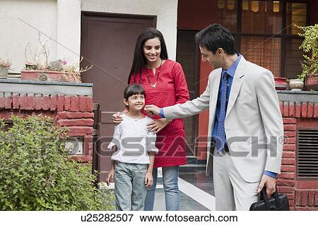 Businessman saying goodbye to his wife and daughter View Large Photo Image Stock Photo - Businessman saying goodbye to his wife and daughter. Fotosearch
