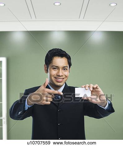 Businessman showing a blank business card View Large Photo Image Stock Photo - Businessman showing a blank business card. Fotosearch