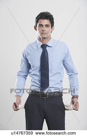Businessman showing his empty pockets View Large Photo Image Stock Photo - Businessman showing his empty pockets. Fotosearch