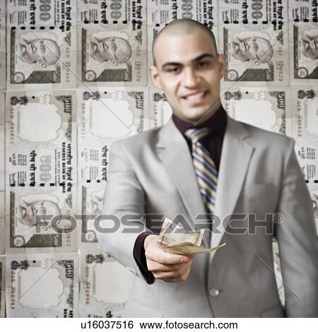 Businessman showing money View Large Photo Image Stock Photograph - Businessman showing money. Fotosearch