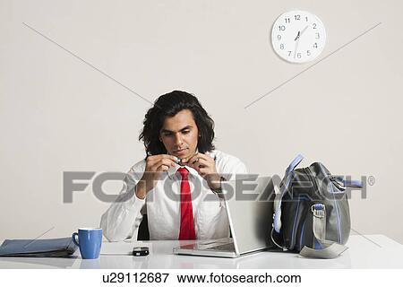 Businessman sitting at the desk View Large Photo Image Stock Photo - Businessman sitting at the desk. Fotosearch