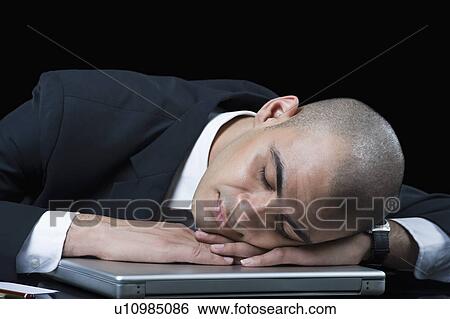 Businessman sleeping on a laptop View Large Photo Image Stock Photograph - Businessman sleeping on a laptop. Fotosearch