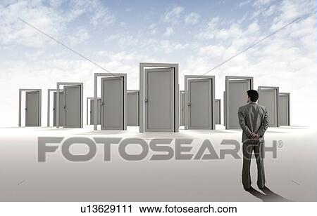 Businessman standing in front of doors View Large Photo Image Stock Image - Businessman standing in front of doors. Fotosearch