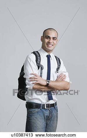 Stock Image - Businessman standing with his arms crossed. Fotosearch