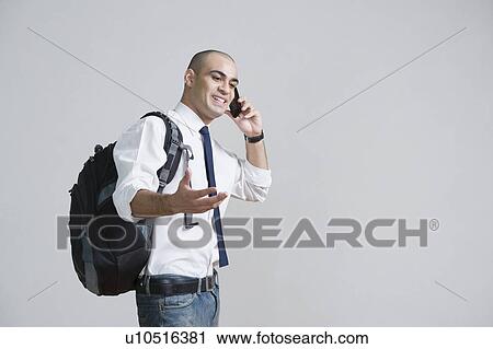 Businessman talking on a mobile phone View Large Photo Image Stock Image - Businessman talking on a mobile phone. Fotosearch