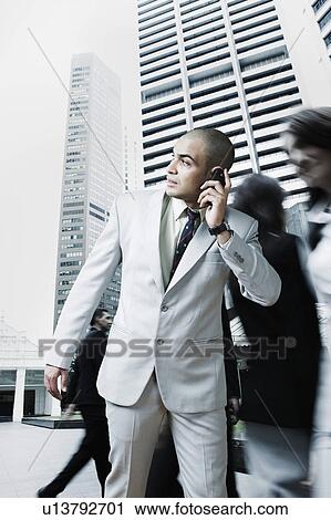 Businessman talking on a mobile phone View Large Photo Image Stock Image - Businessman talking on a mobile phone. Fotosearch