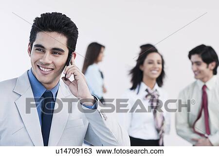 Stock Image - Businessman talking on a mobile phone. Fotosearch