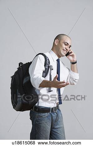 Businessman talking on a mobile phone View Large Photo Image Stock Photo - Businessman talking on a mobile phone. Fotosearch