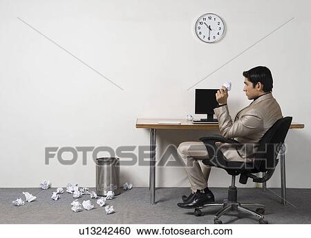 Businessman throwing crumpled paper into garbage bin View Large Photo Image Stock Image - Businessman throwing crumpled paper into garbage bin. Fotosearch