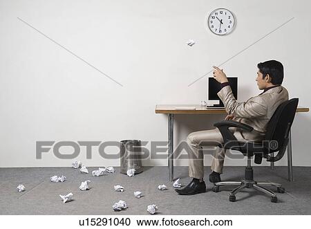 Businessman throwing crumpled paper into garbage bin View Large Photo Image Stock Image - Businessman throwing crumpled paper into garbage bin. Fotosearch