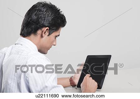 Businessman using a digital tablet View Large Photo Image Stock Image - Businessman using a digital tablet. Fotosearch