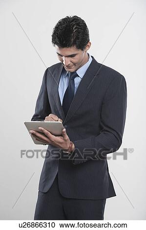 Businessman using a digital tablet View Large Photo Image Stock Image - Businessman using a digital tablet. Fotosearch