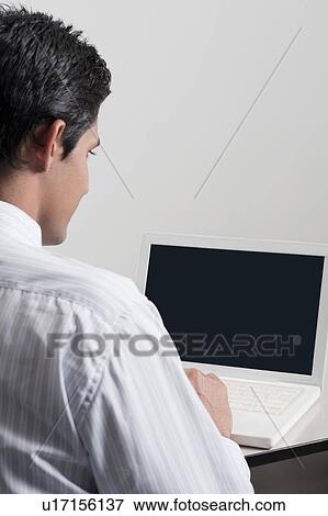 Stock Photo - Businessman using a laptop. Fotosearch