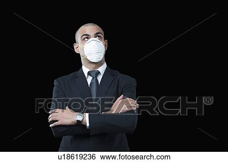 Businessman wearing a pollution mask View Large Photo Image Stock Photograph - Businessman wearing a pollution mask. Fotosearch