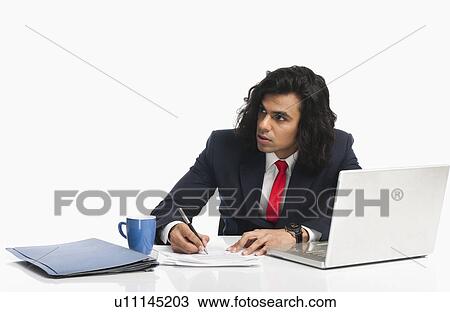 Stock Image - Businessman working in an office. Fotosearch