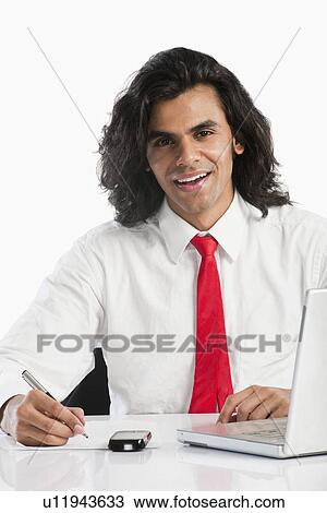 Businessman working in an office View Large Photo Image Stock Image - Businessman working in an office. Fotosearch