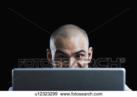 Stock Photo - Businessman working on a laptop. Fotosearch