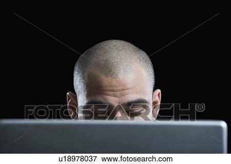 Businessman working on a laptop View Large Photo Image Stock Photo - Businessman working on a laptop. Fotosearch