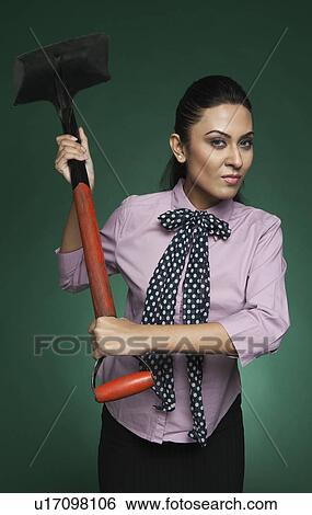 Businesswoman attacking with a shovel View Large Photo Image Stock Photograph - Businesswoman attacking with a shovel. Fotosearch