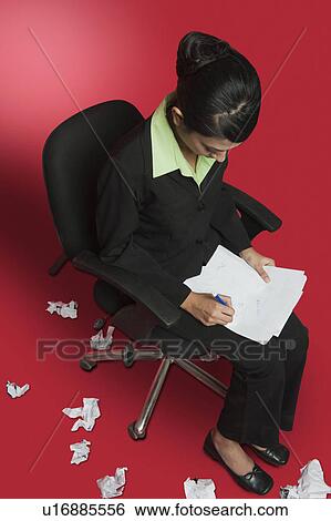 Businesswoman doing paperwork and surrounded with crumpled papers View Large Photo Image Stock Photograph - Businesswoman doing paperwork and surrounded with crumpled papers. Fotosearch
