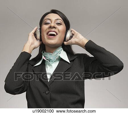 Businesswoman enjoying music on headphones View Large Photo Image Stock Image - Businesswoman enjoying music on headphones. Fotosearch