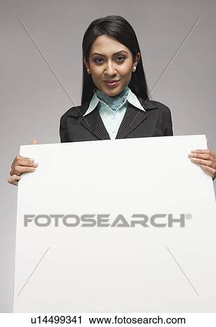 Stock Image - Businesswoman holding a placard. Fotosearch