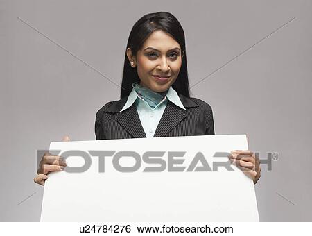 Stock Photograph - Businesswoman holding a placard. Fotosearch