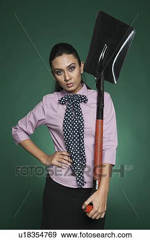 Businesswoman holding a shovel View Large Photo Image Stock Photo - Businesswoman holding a shovel. Fotosearch