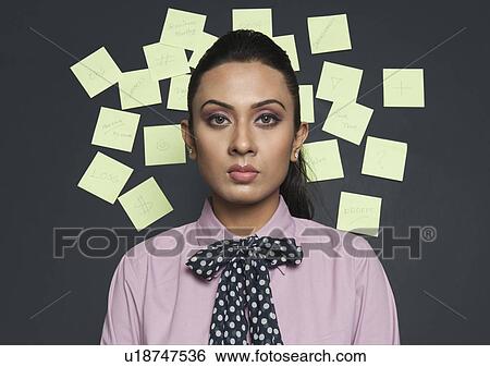 Stock Photograph - Businesswoman in front of a bulletin board. Fotosearch