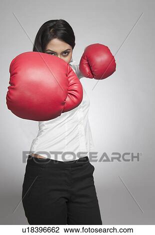 Businesswoman punching with boxing gloves View Large Photo Image Stock Image - Businesswoman punching with boxing gloves. Fotosearch