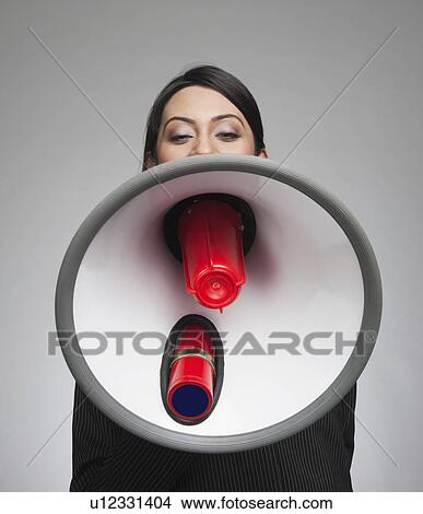 Businesswoman shouting into a megaphone View Large Photo Image Picture - Businesswoman shouting into a megaphone. Fotosearch