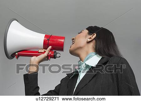 Businesswoman shouting into a megaphone View Large Photo Image Stock Image - Businesswoman shouting into a megaphone. Fotosearch