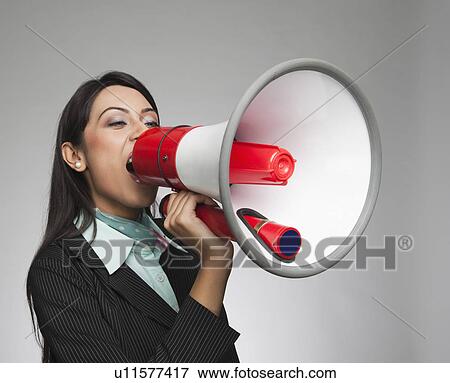 Businesswoman shouting into a megaphone View Large Photo Image Stock Photo - Businesswoman shouting into a megaphone. Fotosearch