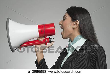 Businesswoman shouting into a megaphone View Large Photo Image Stock Photo - Businesswoman shouting into a megaphone. Fotosearch