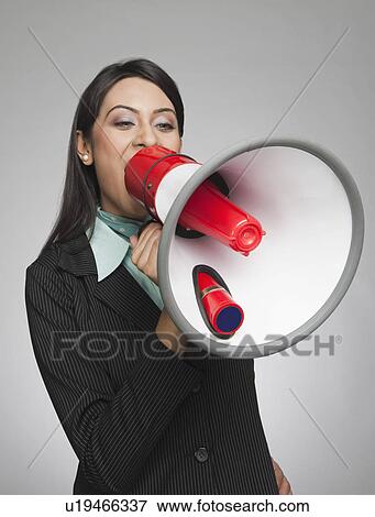 Businesswoman shouting into a megaphone View Large Photo Image Stock Photo - Businesswoman shouting into a megaphone. Fotosearch