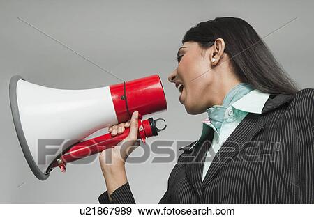 Stock Photo - Businesswoman shouting into a megaphone. Fotosearch