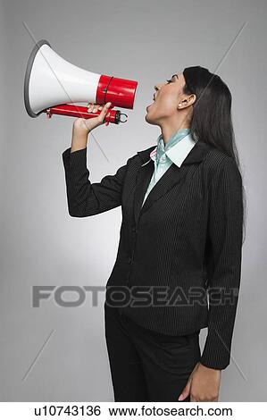 Businesswoman shouting into a megaphone View Large Photo Image Stock Photograph - Businesswoman shouting into a megaphone. Fotosearch