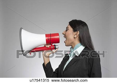 Stock Photography - Businesswoman shouting into a megaphone. Fotosearch