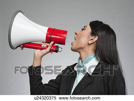 Businesswoman shouting into a megaphone View Large Photo Image Stock Photography - Businesswoman shouting into a megaphone. Fotosearch