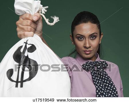 Businesswoman showing a money bag View Large Photo Image Stock Photo - Businesswoman showing a money bag. Fotosearch