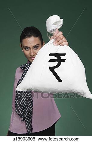 Stock Photo - Businesswoman showing a money bag with Indian rupee symbol on it. Fotosearch