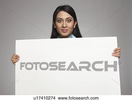 Picture - Businesswoman showing a placard. Fotosearch